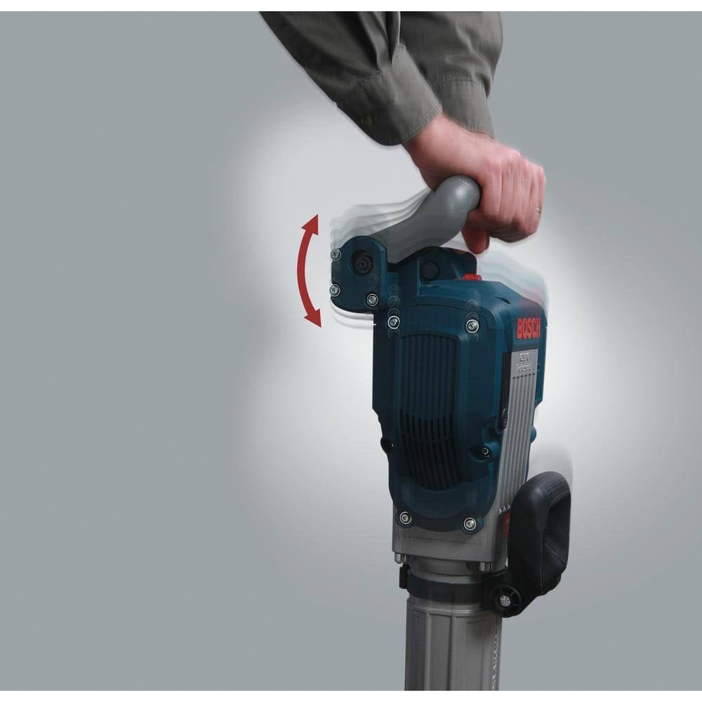 A person's hand holding the top handle of the breaker hammer, with motion graphics illustrating the shock-reducing movement of the Vibration Control system.