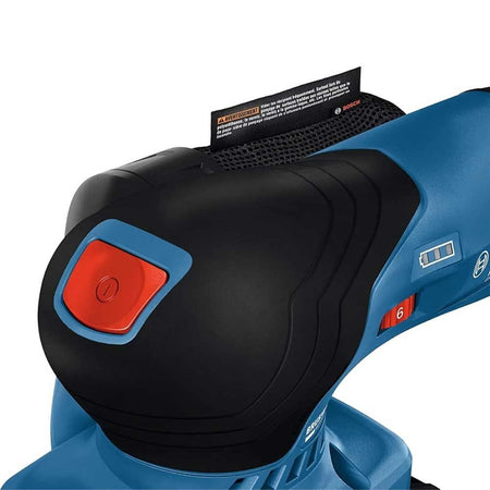 Bosch handheld sander with red power button and speed dial; warning label inserted into dust collection vent.