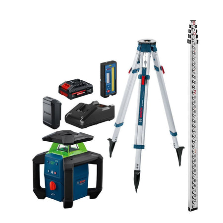 The Bosch 18V Green Beam Horizontal Vertical Rotary Laser Kit GRL18V-34K is fully laid out against a white background. This complete construction grading transit tool kit includes the green beam rotary laser unit, an 18V Core lithium-ion battery pack, a desktop fast battery charger, an alkaline battery adapter, an LR20 laser receiver, a heavy-duty aluminum tripod stand, and a telescoping grade rod.
