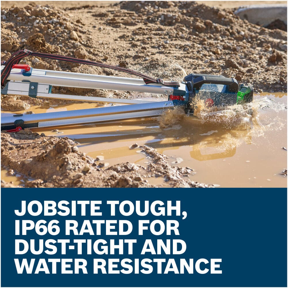An outdoor action shot shows the aluminum building tripod stand tipped over sideways, sending the attached Bosch rotary laser crashing into a muddy water puddle on an earthmoving construction site. Graphic banner text below emphasizes that the tool is job-site tough and IP66 rated for dust-tight and water resistance.