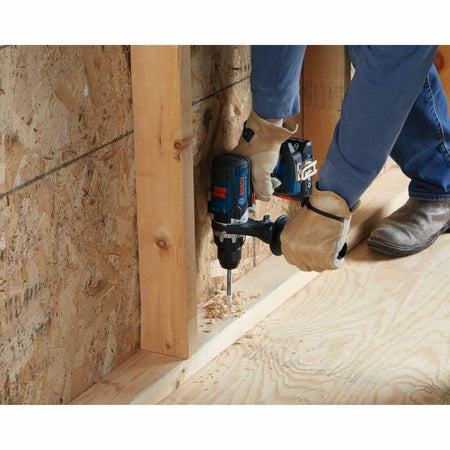 Person using a nail gun on wooden framing