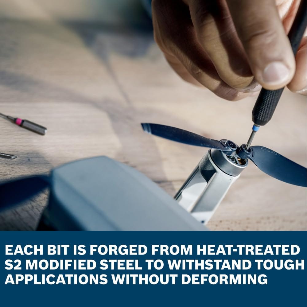 A technician uses a precision screwdriver from the Bosch PB4042 kit to adjust small fasteners on a drone propeller assembly. The overlay text emphasizes that each bit is forged from heat-treated S2 modified steel to handle tough fastening applications without deforming.