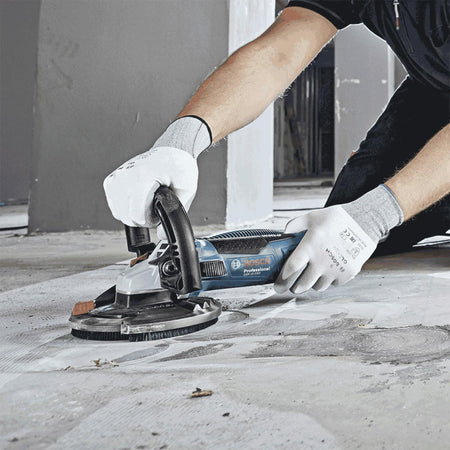 BOSCH DC730H 7 In. Turbo Row Diamond Cup Wheel with 5/8-11 Hub used on concrete surface with angle grinder.