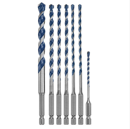 A clean studio product shot of the seven assorted masonry drill bits included in the Bosch BXH7S kit arranged symmetrically by size from tallest to shortest against a solid white background, showcasing their individual 1/4-inch hex mounting shanks, varying lengths of blue-painted spiral flutes, and precision-ground carbide cutting points.