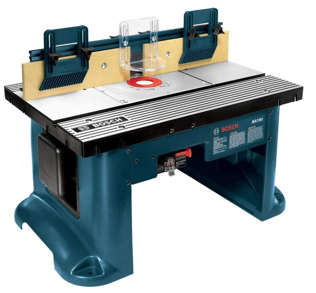 Angled studio view of the Bosch RA1181 benchtop router table showing the aluminum tabletop, adjustable featherboards, and extra tall aluminum fence assembly