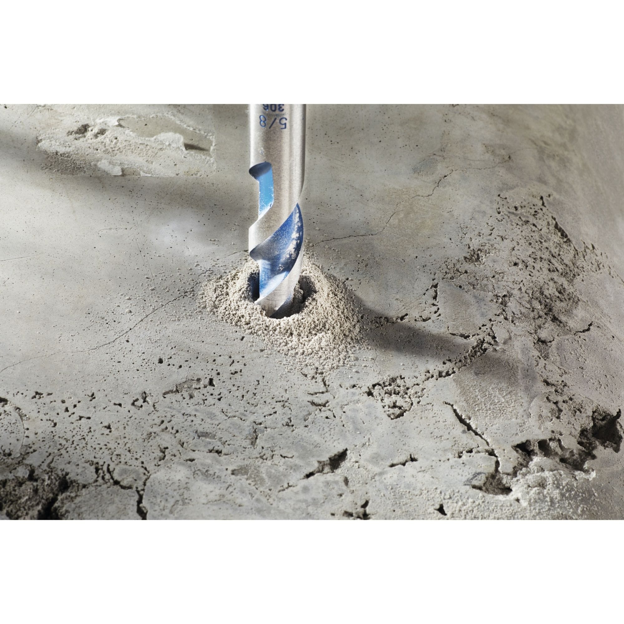 A high-resolution product close-up of the multi-grind carbide tip on the Bosch BlueGranite Turbo masonry drill bit, showcasing the specialized sharp cutting edges, the integrated blue spiral U-flute for efficient dust removal, and the tungsten carbide insert built for impact durability in aggregate materials.