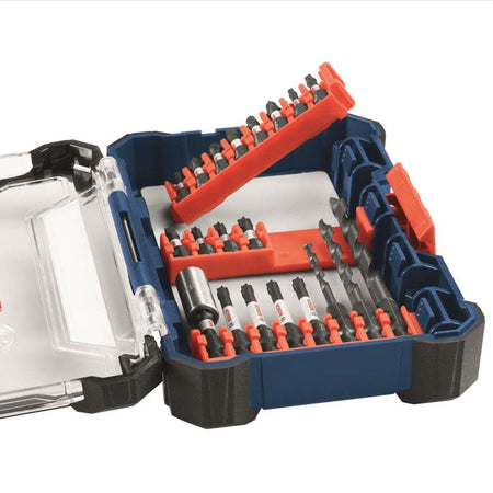 An elevated product studio shot of an opened dark blue Bosch custom case modular storage system layout, showcasing multiple orange clip rails containing assorted driver bits and the 8-piece quick-change black oxide twist drill bit set held securely in place.