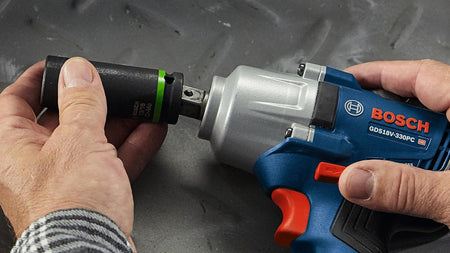 Attaching an impact-rated deep socket onto the 1/2-inch pin detent anvil of the Bosch GDS18V-330PC impact wrench.