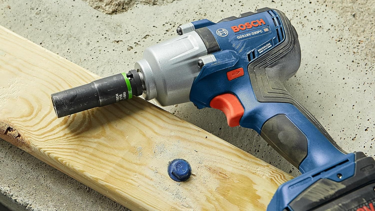 Bosch GDS18V-330PC resting on structural framing timber beside a driven blue heavy-duty concrete anchor screw.