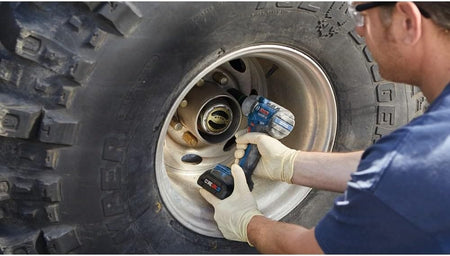 Mechanic removing heavy-duty truck wheel lug nuts using the Bosch GDS18V-330PC 18V cordless impact wrench.