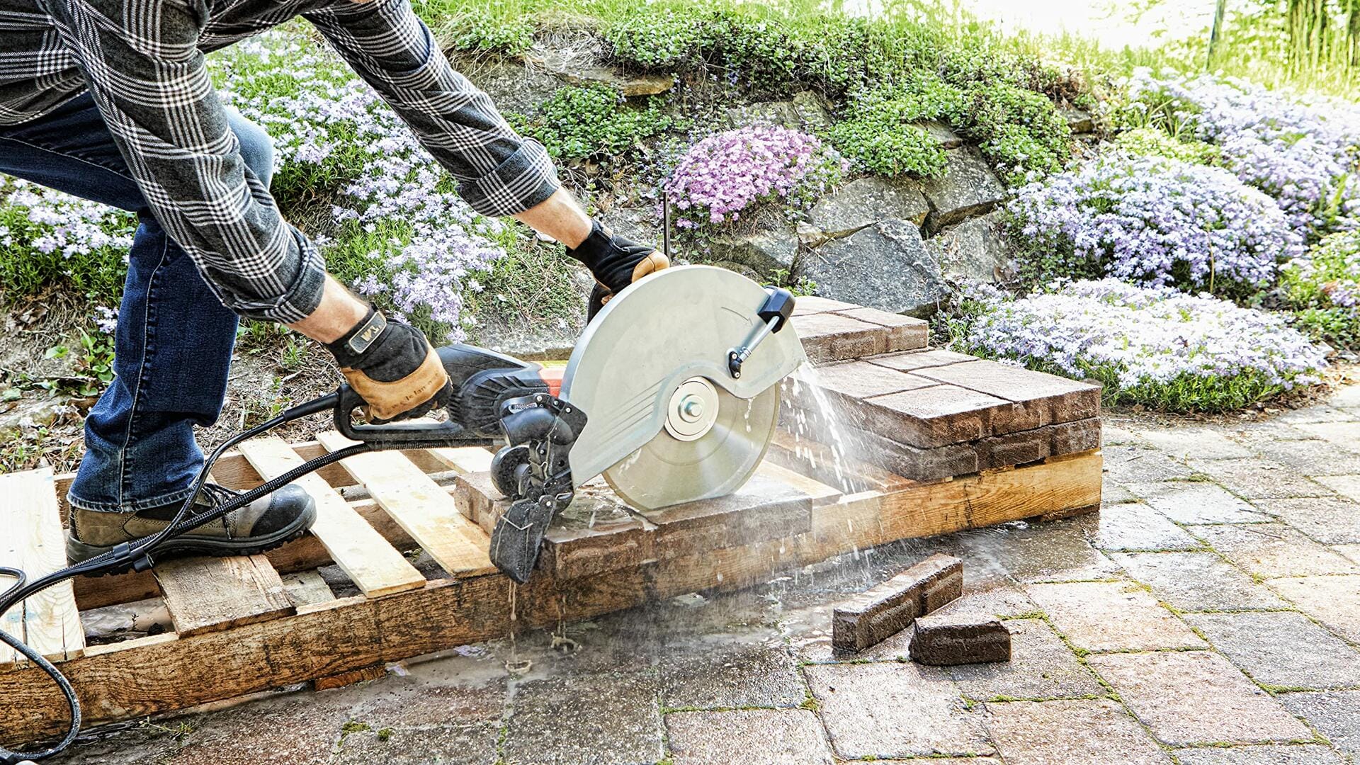 BOSCH DB1241S 12 in. Standard Segmented Rim Diamond Blade cutting bricks on a wet/dry saw outdoors.
