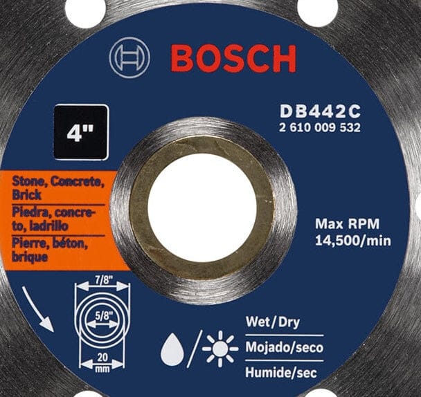 A close-up studio photograph of a silver Bosch 4-inch diamond blade center label, highlighting the 5/8-inch arbor and max RPM of 14,500.