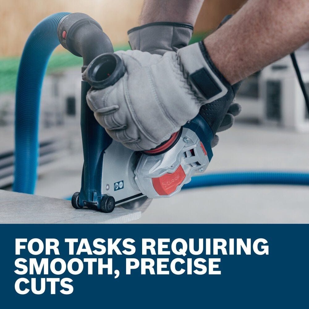 A close-up action shot of an operator using a Bosch grinder with an attached dust shroud to perform smooth, precise cuts on a concrete surface.