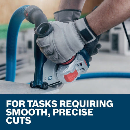 A close-up action shot of an operator using a Bosch grinder with an attached dust shroud to perform smooth, precise cuts on a concrete surface.