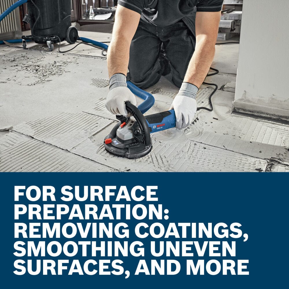 An indoor jobsite application shot showing a construction worker on his knees handling a shrouded concrete floor grinder across a wide tile surface prep area, with large white text block overlaying stating For Surface Preparation: Removing Coatings, Smoothing Uneven Surfaces, and More.