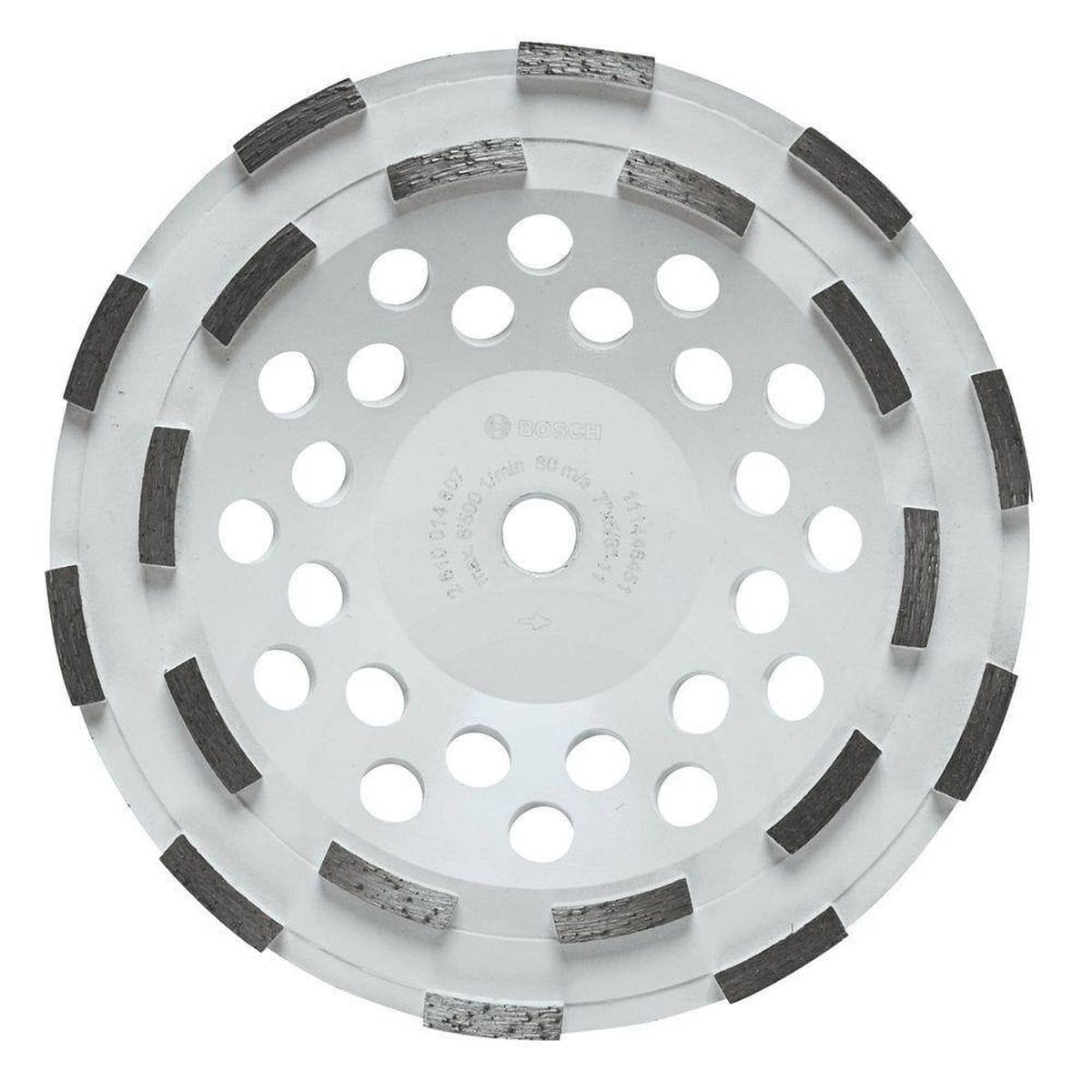 Product studio shot from a direct overhead view of the Bosch DC710H 7 Inch Double Row Segmented Rim Diamond Cup Wheel on a white background, displaying its wide white steel body, a 5/8-11 threaded center arbor hole, multiple concentric rings of round heat dissipation vents, and 12 aggressively arranged double-row segmented diamond cutting teeth.