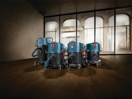 Group shot of Bosch VAC series dust extractors compatible with the plastic disposal bags arranged in a workshop setting.