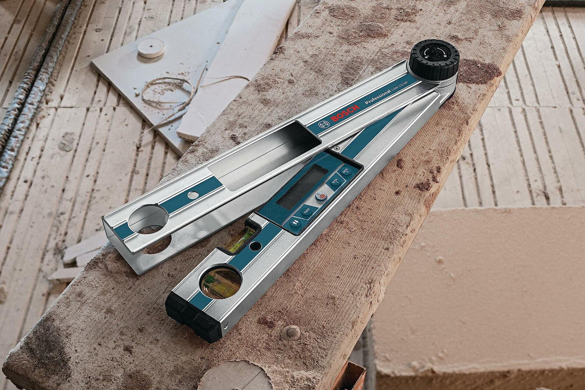Overhead close-up of the Bosch GAM 220 MF digital angle finder opened to measure an angle, resting on rough construction lumber