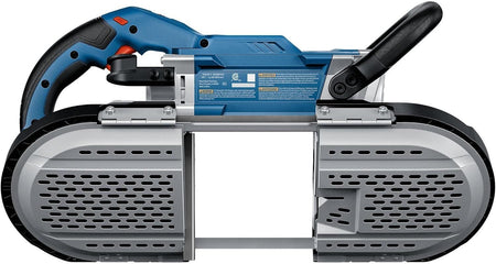 A view of the underside of the band saw, displaying the protective metal blade guard plate and warning safety labels.