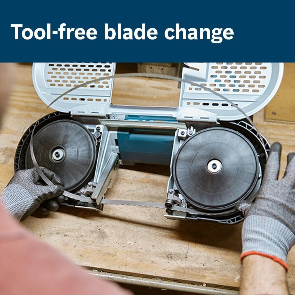A close-up view of the band saw with the protective cover open, showing a gloved user installing a new blade without tools.