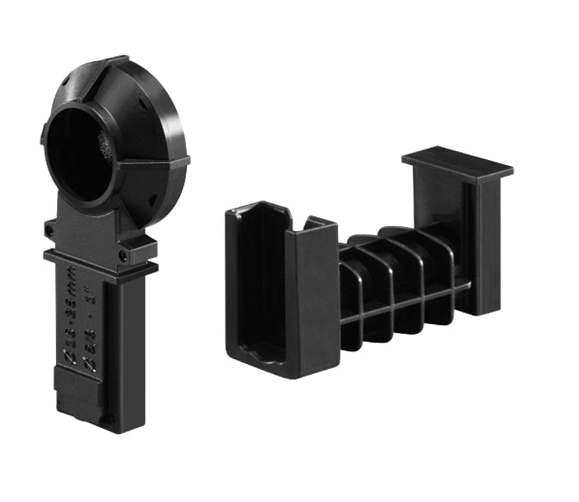 Two black plastic components used for cable management or mounting, one with a circular guide and one with parallel fins.


