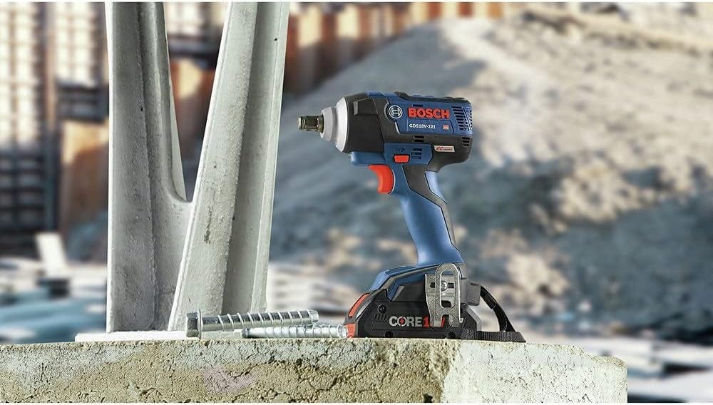 Bosch GDS18V‑221 18V EC Brushless impact wrench positioned upright on a construction site with steel fasteners nearby, showcasing durable design, CORE18V battery power, and high‑torque capability for heavy‑duty fastening tasks.
