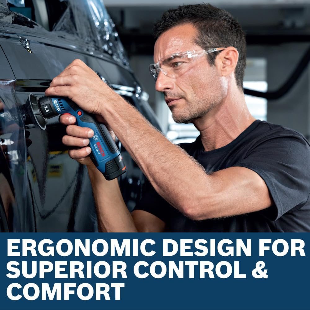 An automotive detailer wearing clear protective glasses utilizing the Bosch GEX12V-77N brushless random orbital sander to refine minor imperfections on a black car door panel. This profile view illustrates the compact tool layout and stable control, enhanced by a lower text box stating Ergonomic design for superior control and comfort.