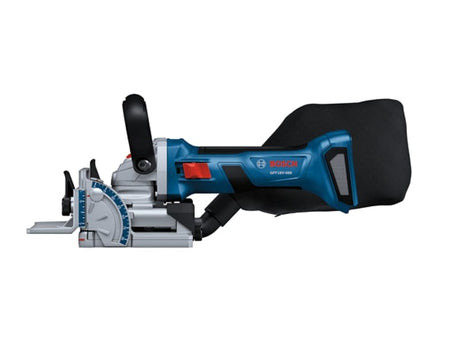 A side-profile studio view of the blue and black Bosch 18V biscuit joiner featuring a large black dust bag attached to the rear dust port and a red power switch on the body.