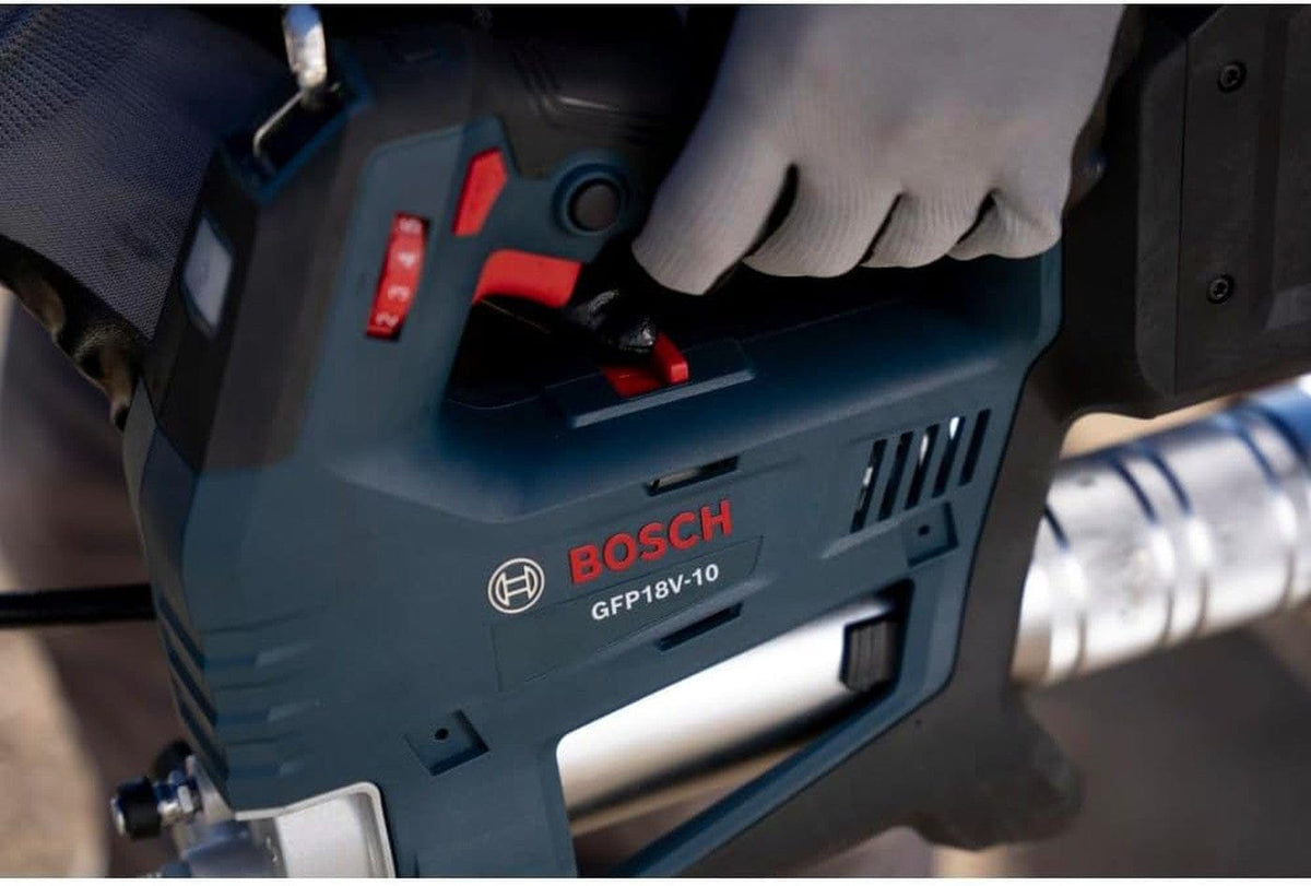 Detail shot of the Bosch 18V grease gun's ergonomic grip and mode selector, highlighting the professional-grade construction and intuitive controls for automotive and equipment servicing.