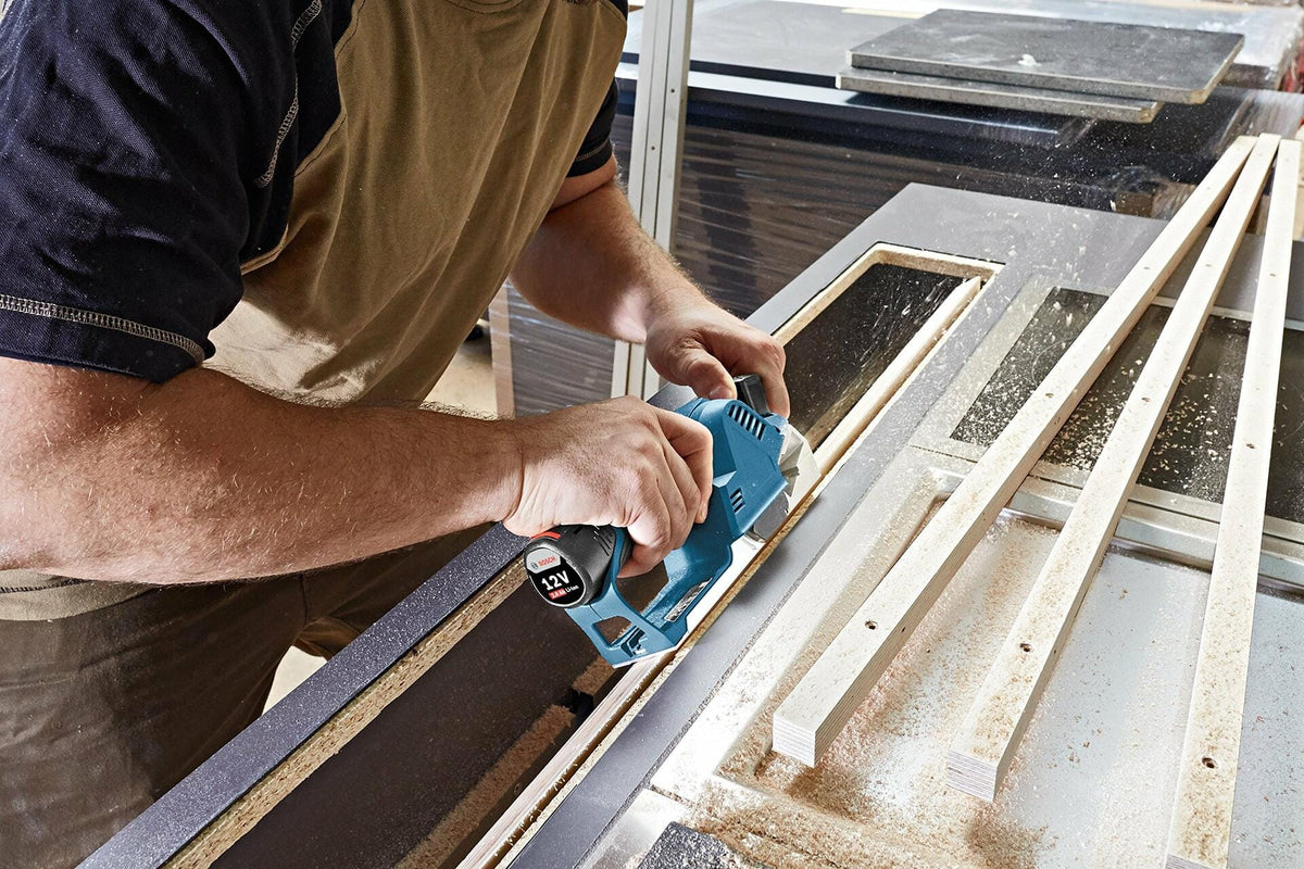 Bosch GHO12V-08N 12V Max Cordless Brushless Hand Planer trimming wood with compact design for precision finishing