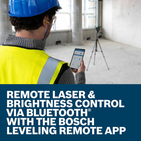 A worker standing in a large commercial space viewing a smartphone screen to control a tripod-mounted laser level in the distance, illustrating the text Remote Laser and Brightness Control via Bluetooth with the Bosch Leveling Remote App.