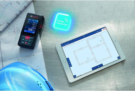 Bosch GLM400CL laser measure next to tablet with floor plan; workspace includes blueprints and "Simply. Connected." signage.