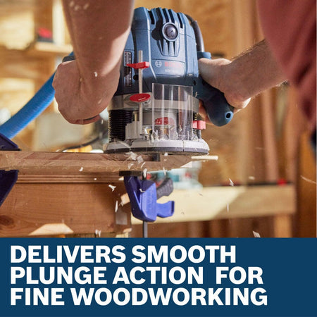 A carpenter utilizing the Bosch GOF13-25 1-3/4 HP mid-size plunge router to mill out a precise decorative trim edge line along a wooden workbench board clamped securely to a workstation base. The close-up view captures wood shavings spraying from the transparent sub-base cutting window, set above a lower marketing banner reading Delivers smooth plunge action for fine woodworking.
