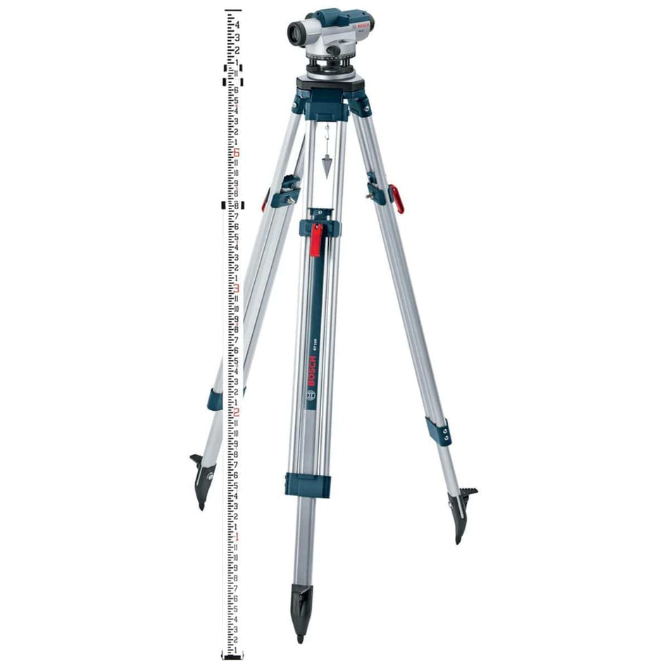 Product studio shot from a full-length perspective of the Bosch GOL26CK automatic optical level instrument mounted securely on a silver aluminum contractor tripod with a metal plumb bob hanging centrally beneath the head, standing next to a vertical telescoping white and red centimeter-graduated leveling grade rod.