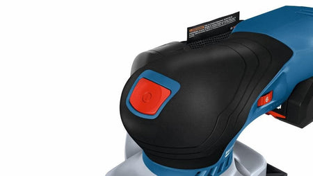 A macro close-up focus on the forward palm rest section of the Bosch finishing sander emphasizing the textured anti-slip surface pattern, the red mechanical power button, and the red variable speed dial set to level 6.