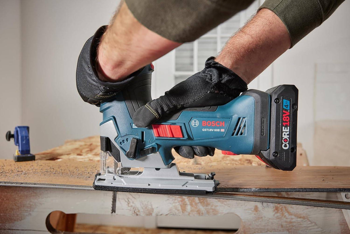 Action shot showing a worker using the barrel-grip jig saw to perform a straight cut through a thick piece of plywood. The user is gripping the top and rear of the tool for stability on a workbench.