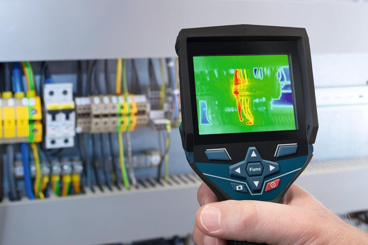 Close-up of the camera display pinpointing an overheating wire connection within a complex electrical panel
