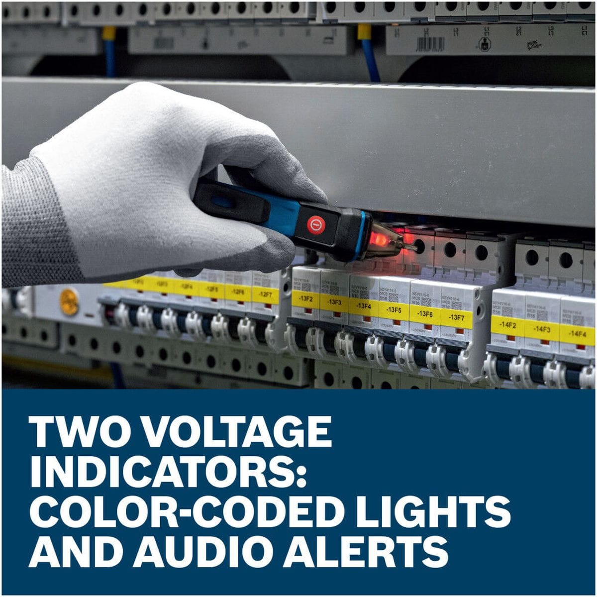 A close-up view of a professional technician's gloved hand holding the Bosch GVD1000-15 tester stick up to a row of commercial circuit breakers. The clear tip glows a strong red to signal active current presence, set above a high-contrast marketing text banner that reads Two voltage indicators: color-coded lights and audio alerts.