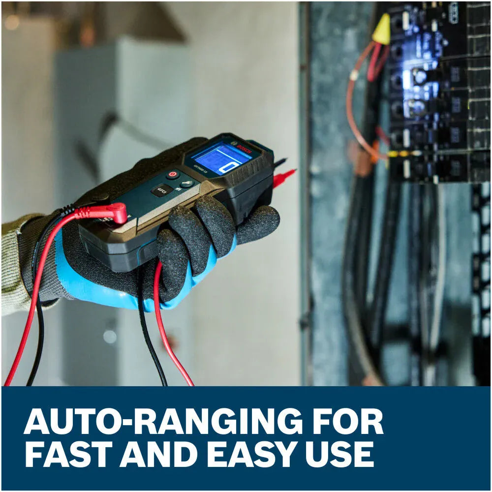 A close-up view of an electrician wearing textured safety gloves holding the Bosch GVT600-13 Auto-Ranging Tester while troubleshooting an open distribution box. The integrated flashlight illuminates the branch circuit wire runs, accompanied by lower marketing text reading Auto-ranging for fast and easy use.