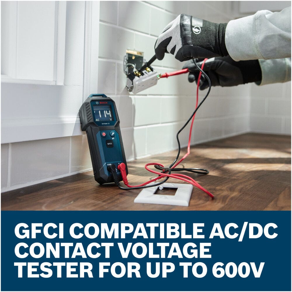 An electrician using the connected red and black test leads of the Bosch GVT600-13 Contact Voltage Tester to check live connections inside a wall socket. The tester stands upright against a white tiled wall displaying an active 114V AC reading, with a lower text graphic reading GFCI compatible AC DC contact voltage tester for up to 600V.