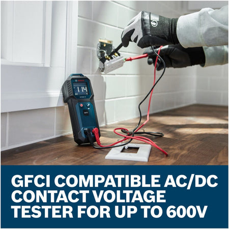 An electrician using the connected red and black test leads of the Bosch GVT600-13 Contact Voltage Tester to check live connections inside a wall socket. The tester stands upright against a white tiled wall displaying an active 114V AC reading, with a lower text graphic reading GFCI compatible AC DC contact voltage tester for up to 600V.