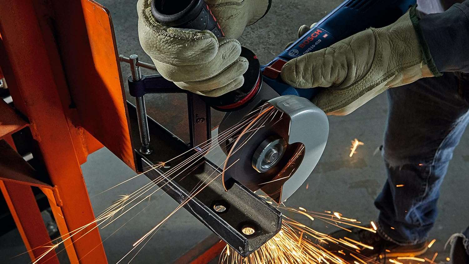 A close-up of the grinder cutting through a metal piece clamped in a vise, with sparks flying downward.