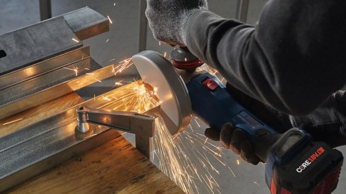 Close-up action shot of the Bosch GWS18V-13C angle grinder cutting through a metal wall stud, showcasing the high-torque performance and industrial-grade cutting speed of the BITURBO motor.