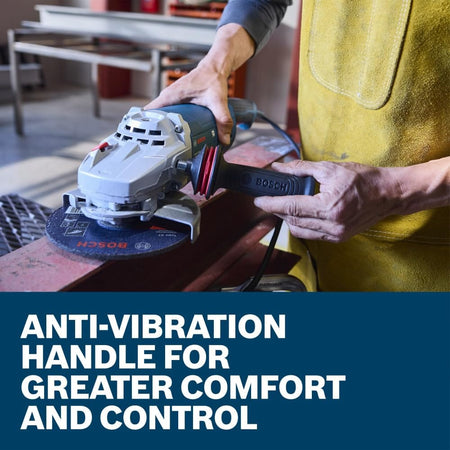 A close-up product use view capturing a workshop fabricator's hand positioning an auxiliary side handle onto the silver gear housing of the Bosch GWS22-180J metal angle grinder. Set precisely above a bold blue lower text box that states Anti-vibration handle for greater comfort and control, the shot underscores how the dampening grip framework maximizes physical stability on the job.