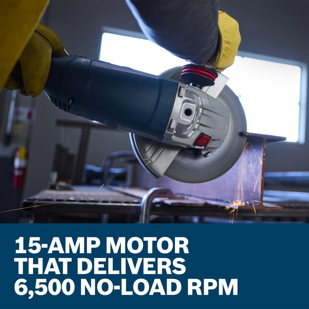 An action close-up showing a workshop fabricator wearing bright yellow leather safety welding gloves operating the Bosch 15-Amp metal angle grinder. The tradesman applies steady mechanical pressure to cut through a thick steel frame bar workpiece on a table setup, set above a lower marketing text banner reading 15-Amp motor that delivers 6,500 no-load RPM.