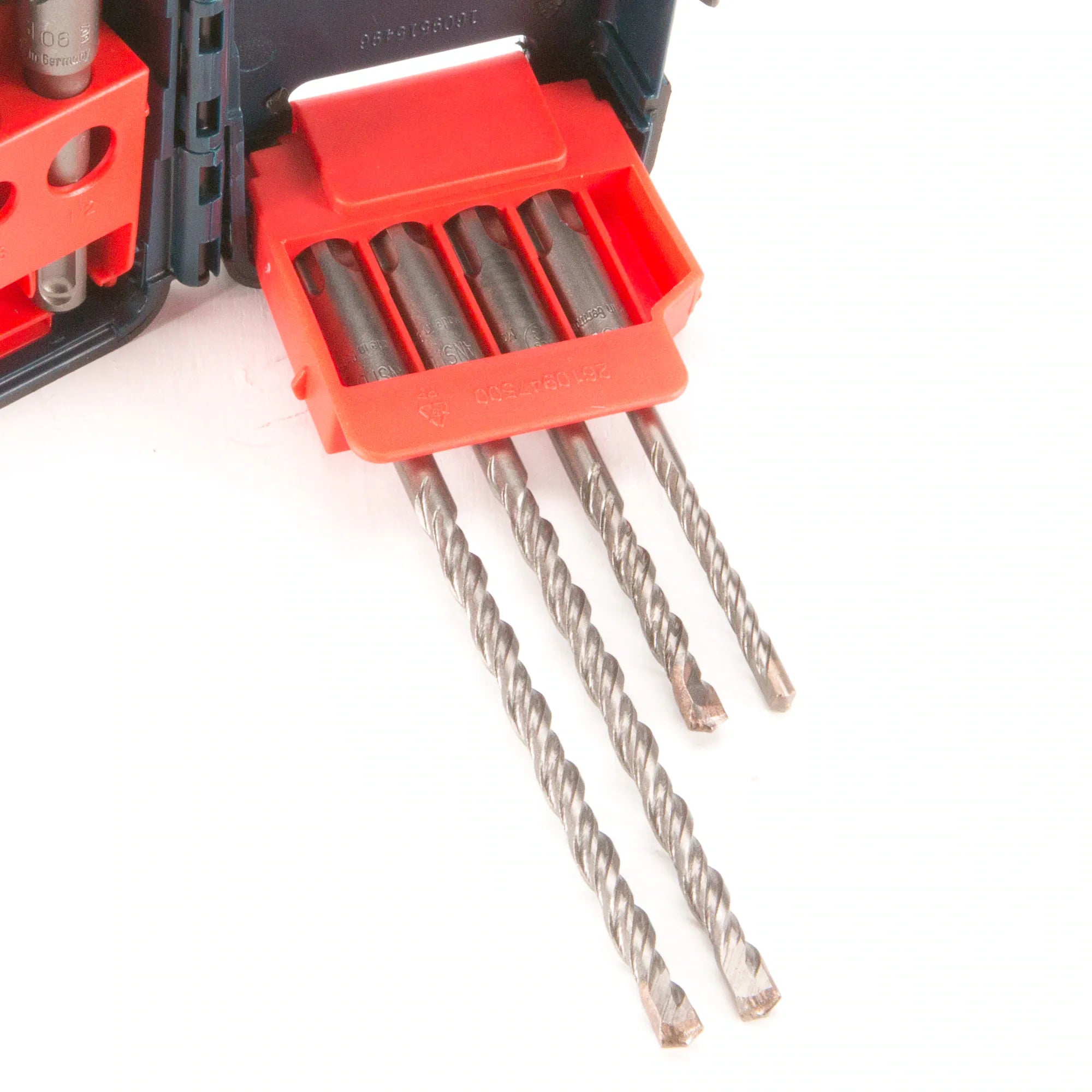 A close-up view of three metal SDS Plus rotary hammer drill bits, part of the Bosch HCK001 Bulldog 7 Piece set, demonstrating the characteristic helical flute design and robust carbide tips optimized for professional, heavy-duty masonry and concrete drilling applications.