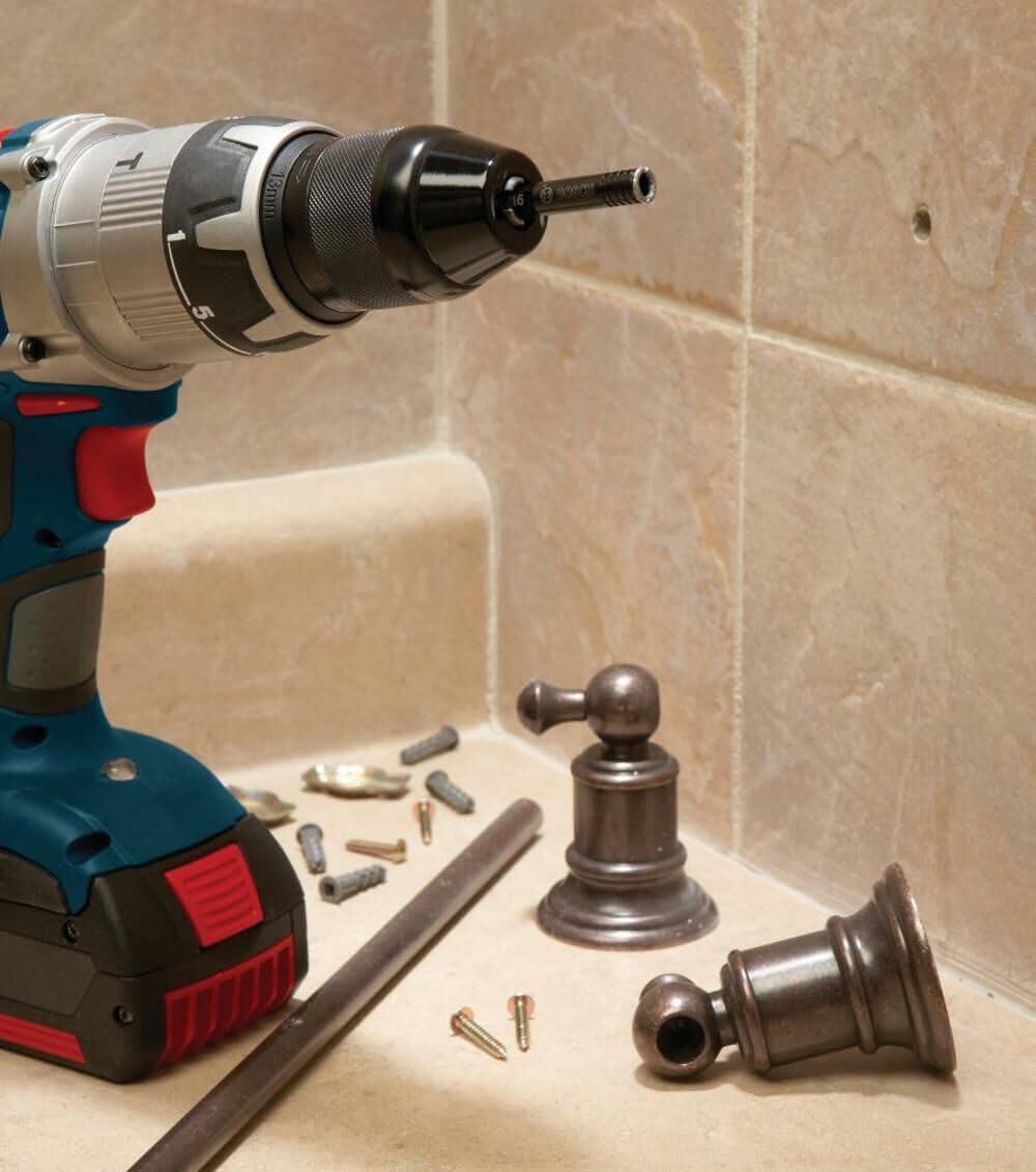 A close-up of a Bosch cordless drill with the AutoStart pilot bit, being used to drill a small, precise hole in a tiled bathroom wall for installing a fixture.