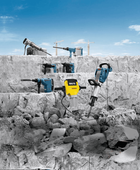 Timeline collage of Bosch demolition hammers on a rocky landscape from 1932 to present, demonstrating the heavy duty power tools compatible with the 1-1/8 inch hex hammer steel digging chisel bit.