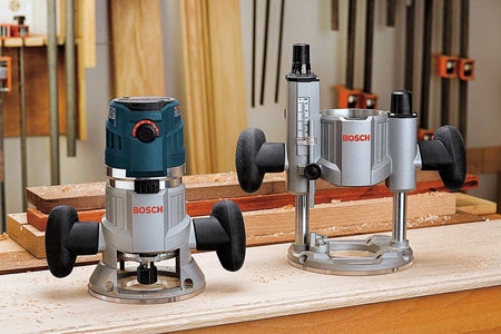 Two Bosch routers on workbench surrounded by wood shavings; fixed-base and plunge-base models in active woodworking shop.