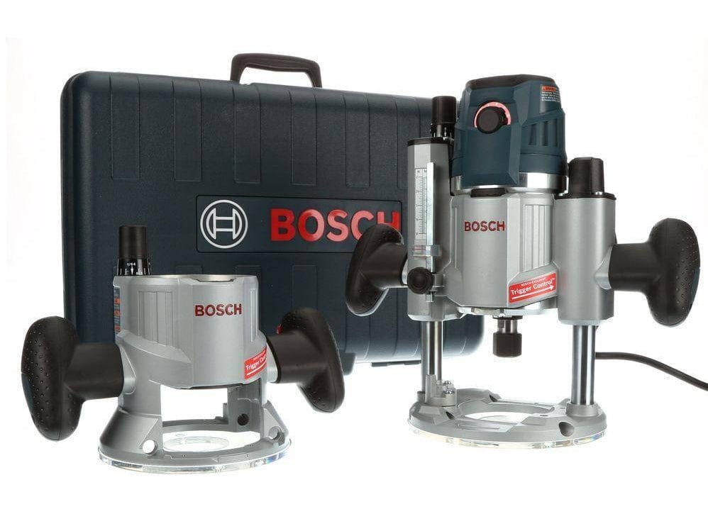 Bosch router kit with motor unit, fixed base, plunge base, and hard carrying case displayed on workshop surface.